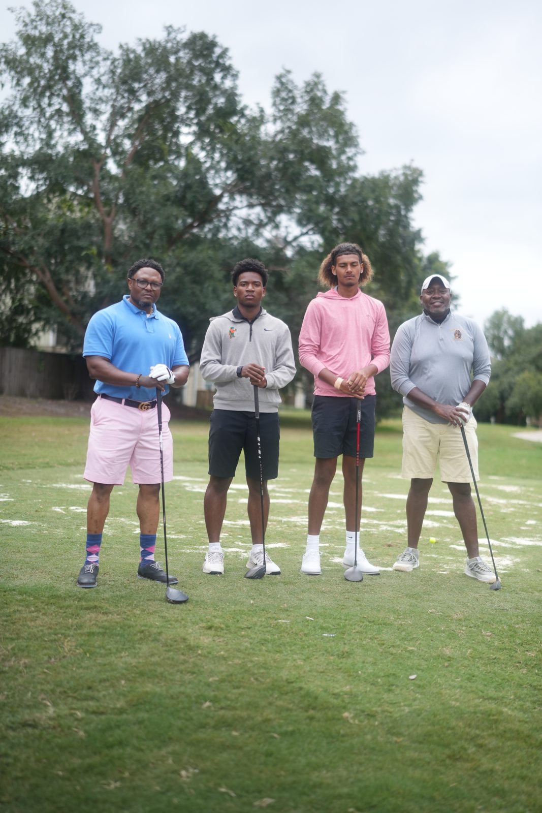 Foursome smiling on the green