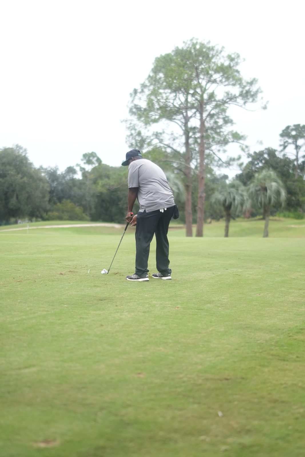 Golfer teeing off down the fairway