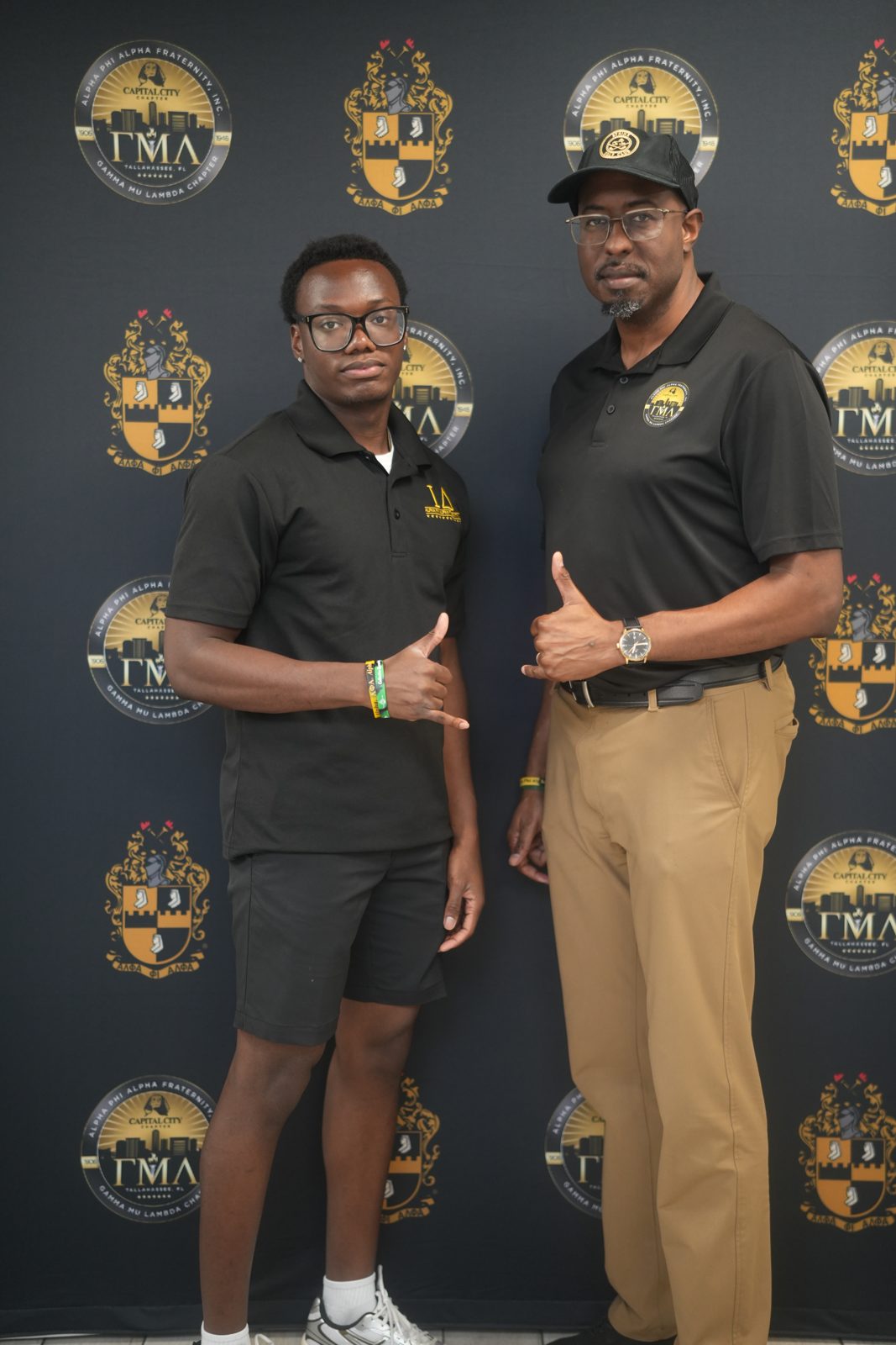 Attendees in front of the tournament backdrop